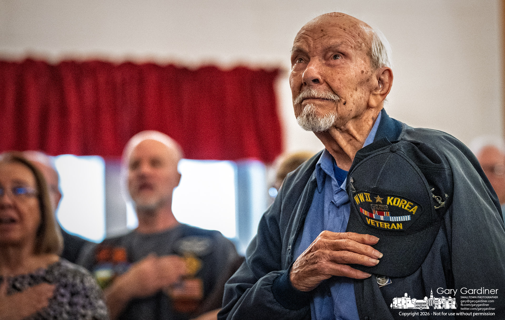 Irwin Kuhns places his hat over his heart during the Pledge of Allegiance at the American Legion, where the World War II and Korean War veteran celebrated his 100th birthday Friday. (My Final Photo for April 3, 2026)