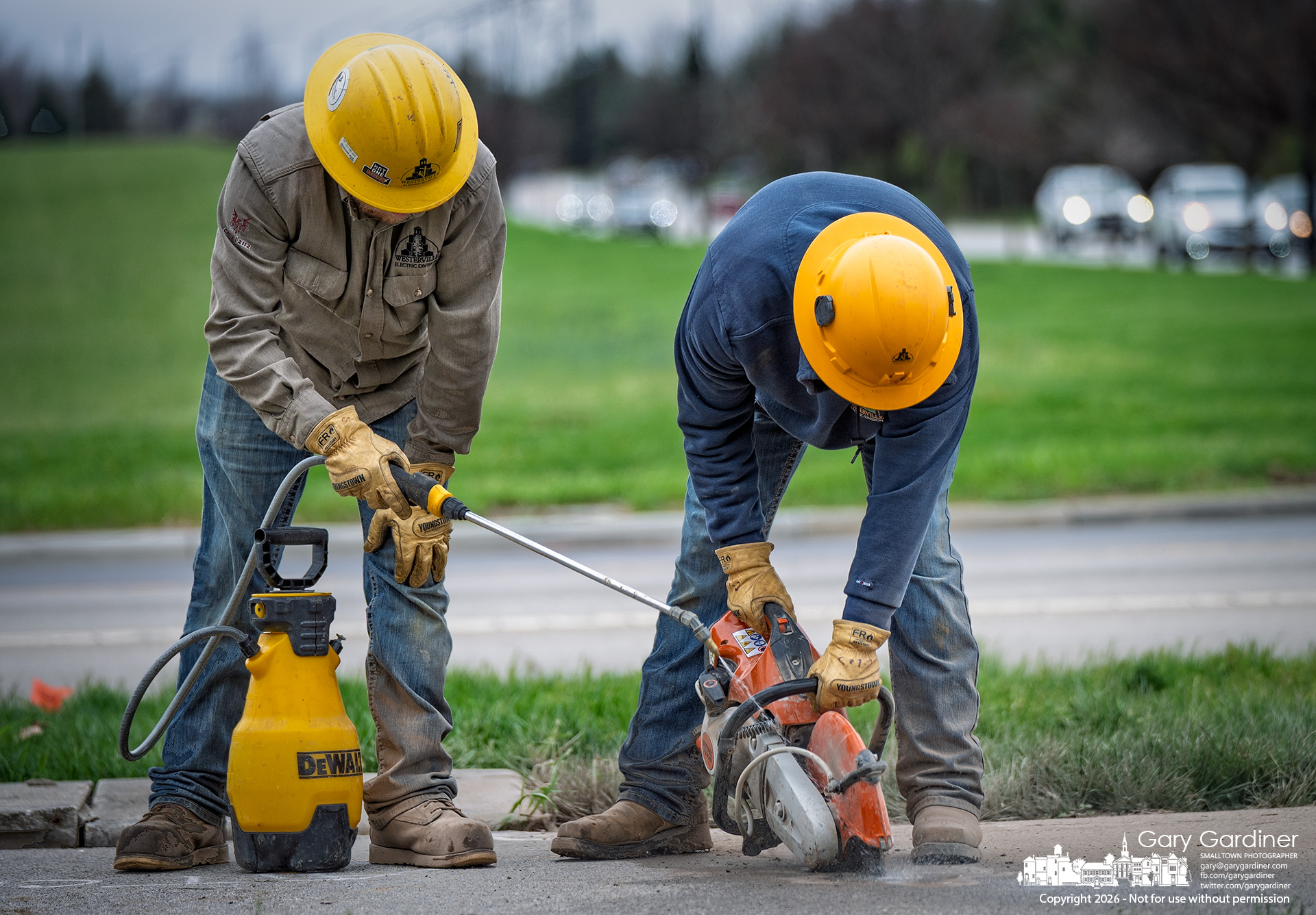 Westerville Electric Division workers cut a trench through a section of the sidewalk to lay conduit and wiring for a new switch at County Line and Africa roads to upgrade the system as East of Africa nears completion. (My Final Photo for April 1, 2026)