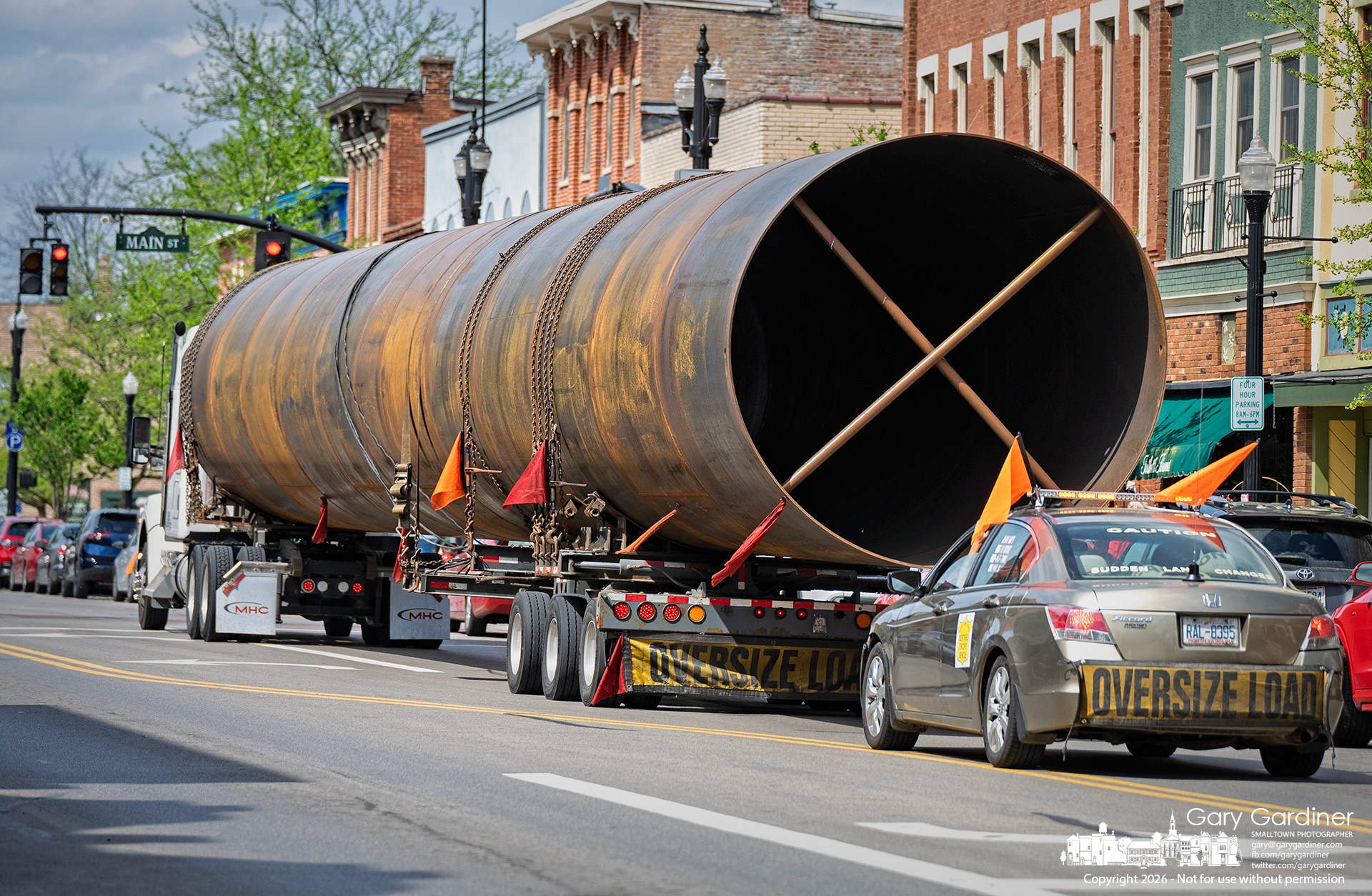 An oversized metal tube of unknown origin, purpose, and destination made its way through uptown Westerville Tuesday afternoon, stopping briefly at the State and Main traffic signal. (My Final Photo for April 14, 2026)