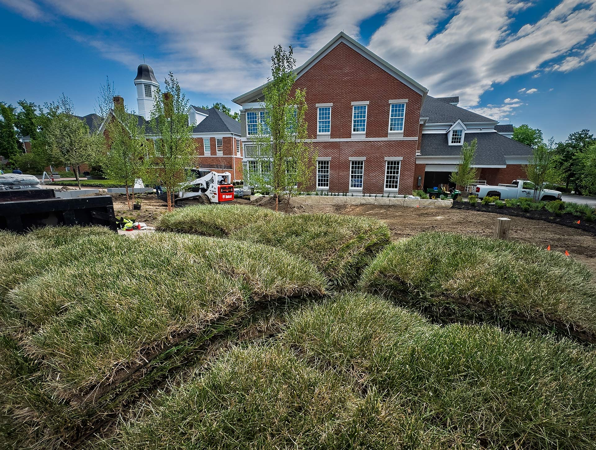 Pallets of grass sod sit at the rear of city hall Monday as the contractor rushes to complete its renovation, as the city began returning to its offices. (My Final Photo for May 11, 2026. Photo by Gary Gardiner)