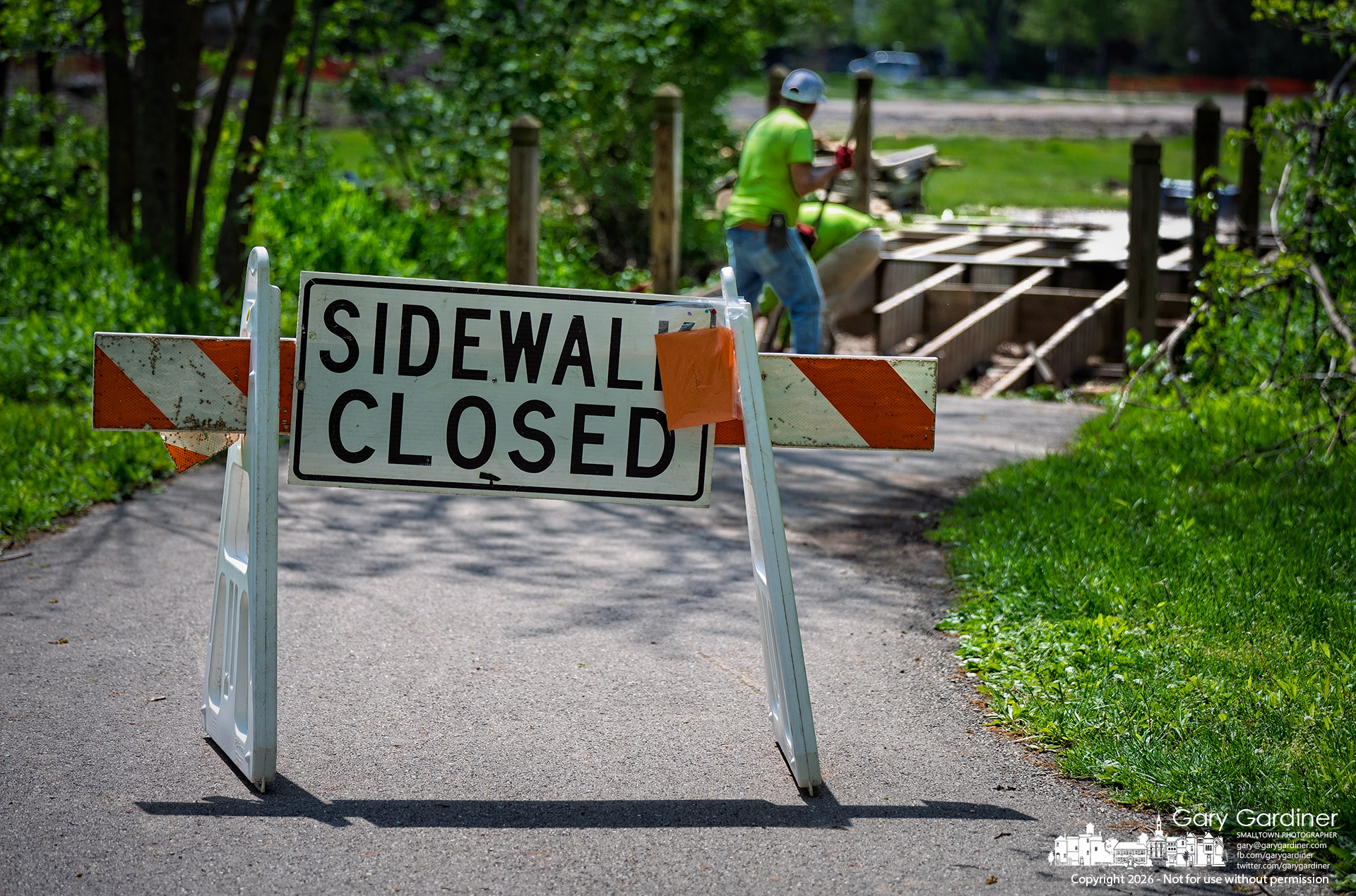 Workers removed the wooden bridge spanning the stream in the outfield at Walnut Ridge Park as the park prepares to rebuild the outfield into a wetland play area. (My Final Photo for May 4, 2026, by Gary Gardiner)