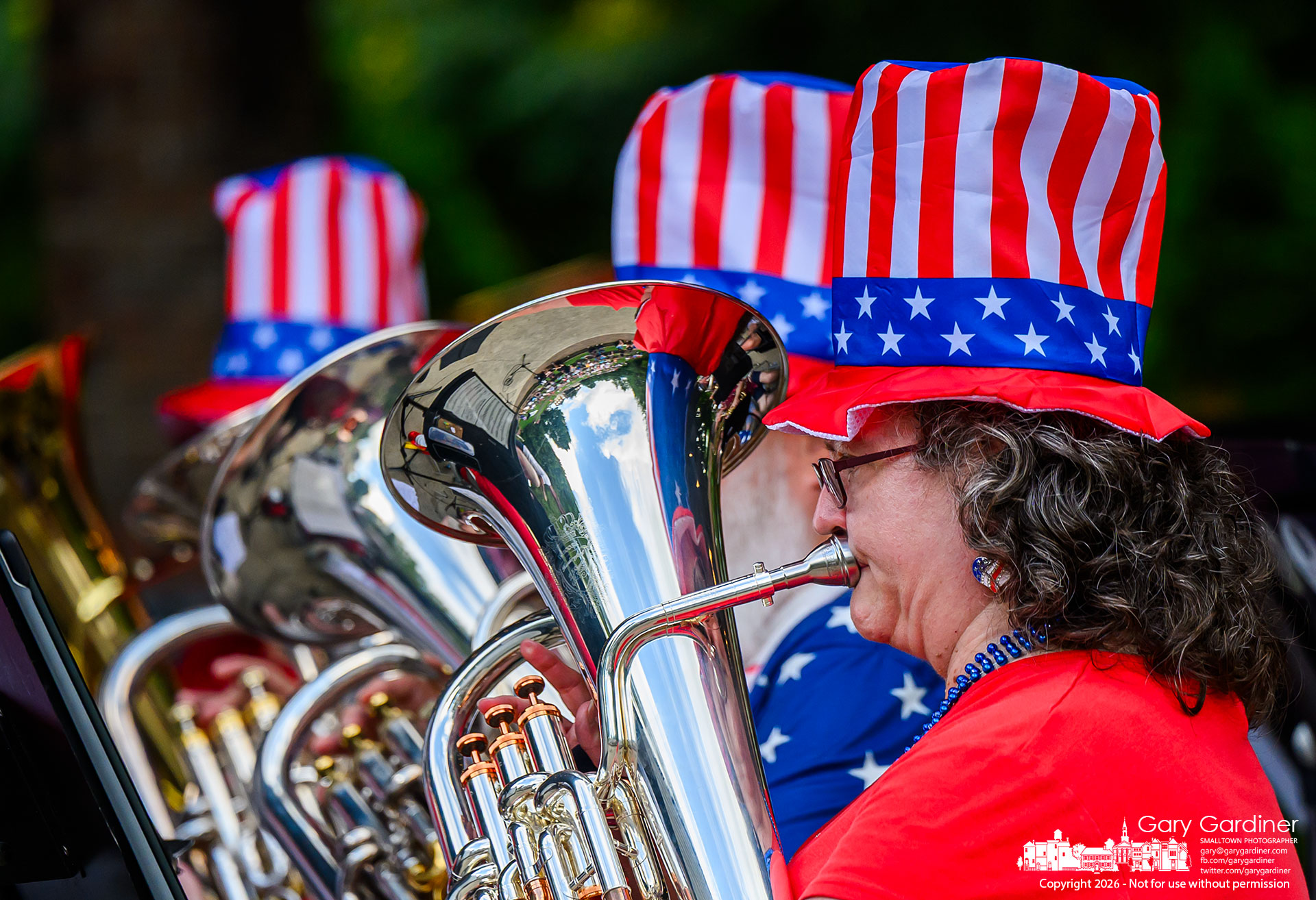 Patriotic stovepipe hats were the proper dress for the brass section performing at the Alum Creek Park Amphitheater Sunday night. (My Final Photo for June 28, 2026. Photo by Gary Gardiner)