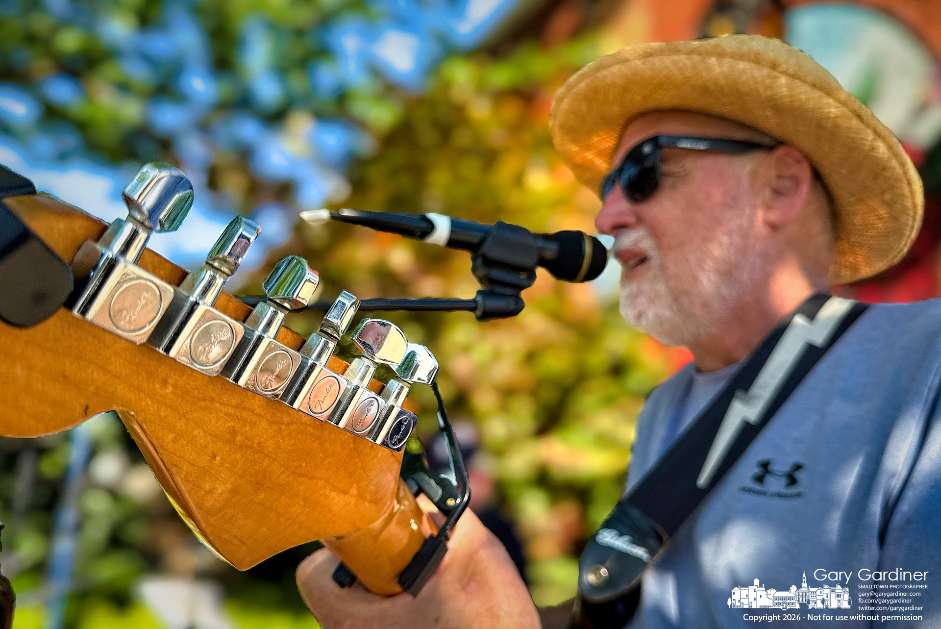 Juke Jammers' Dean Gledhill performs on his six-string guitar in Rotary Park in Uptown Friday Night in Westerville. (My Final Photo for June 12, 2026. Photo by Gary Gardiner)
