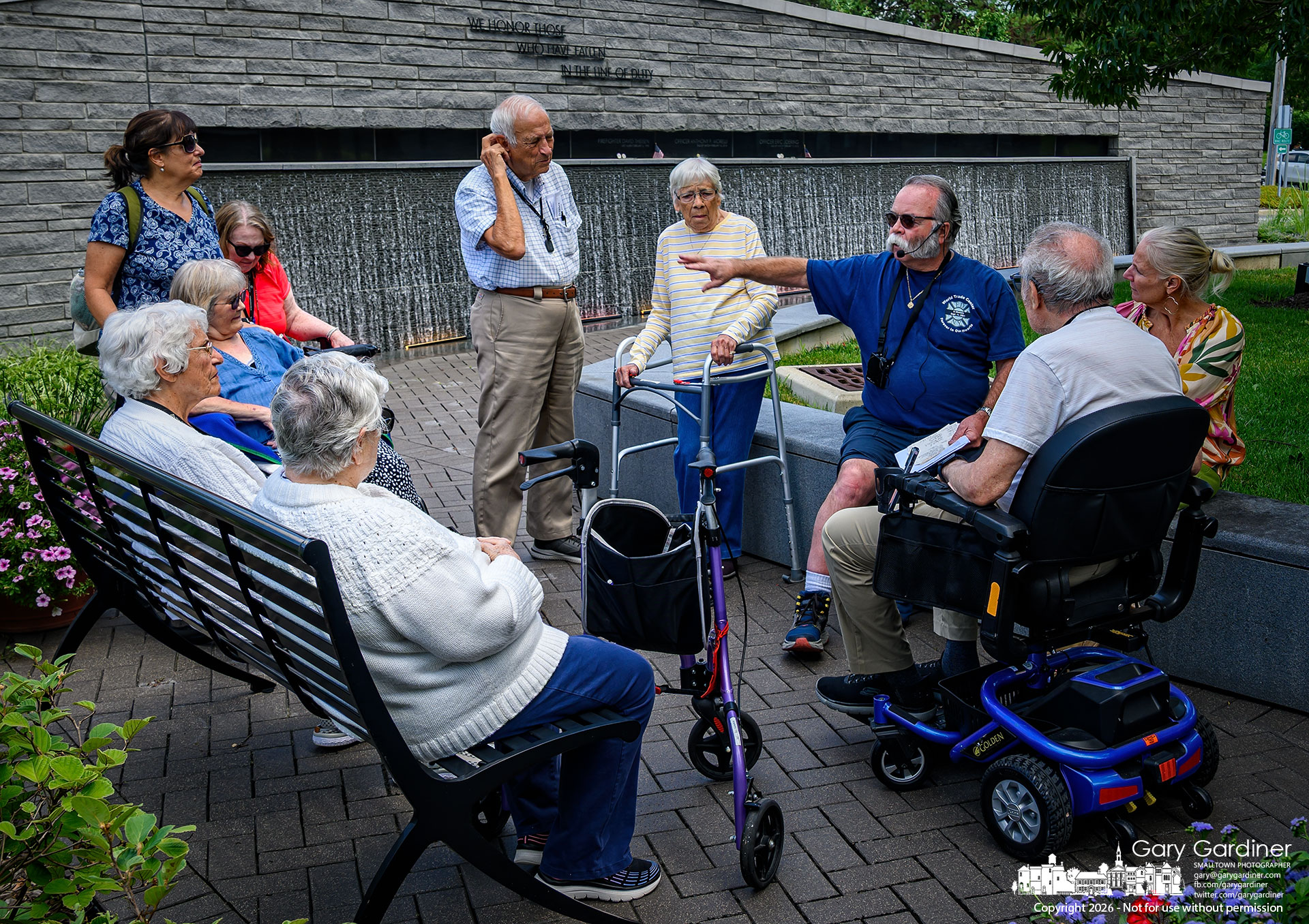 Tom Ullom, retired Westerville firefighter and founder of the Westerville Firefighter Memorial, talks with a group from The Gables retirement community as they tour First Responders Park. (My Final Photo for July 22, 2026. Photo by Gary Gardiner)