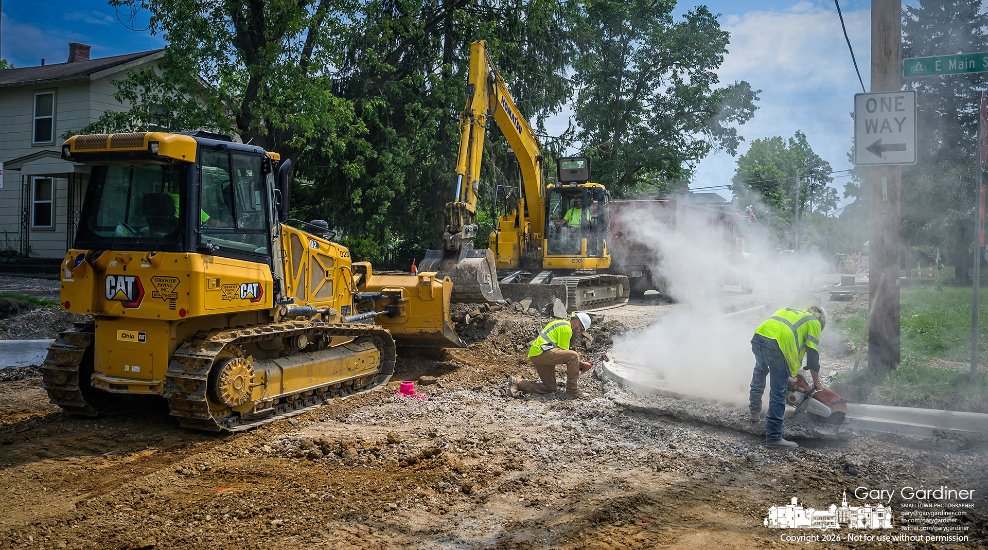 Curbs, gutters, and leveling the road surface were the tasks assigned Monday to the work crew on Voinse Street's rebuilding project. (My Final Photo for July 27, 2026. Photo by Gary Gardiner)