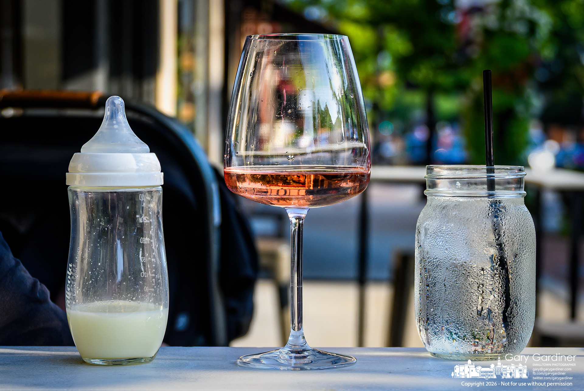 Refreshments for mother, daughter, and granddaughter sit on the granite patio table on the sidewalk in front of Asterisk in Uptown Westerville. (My Final Photo for August 26, 2026. Photo by Gary Gardiner)
