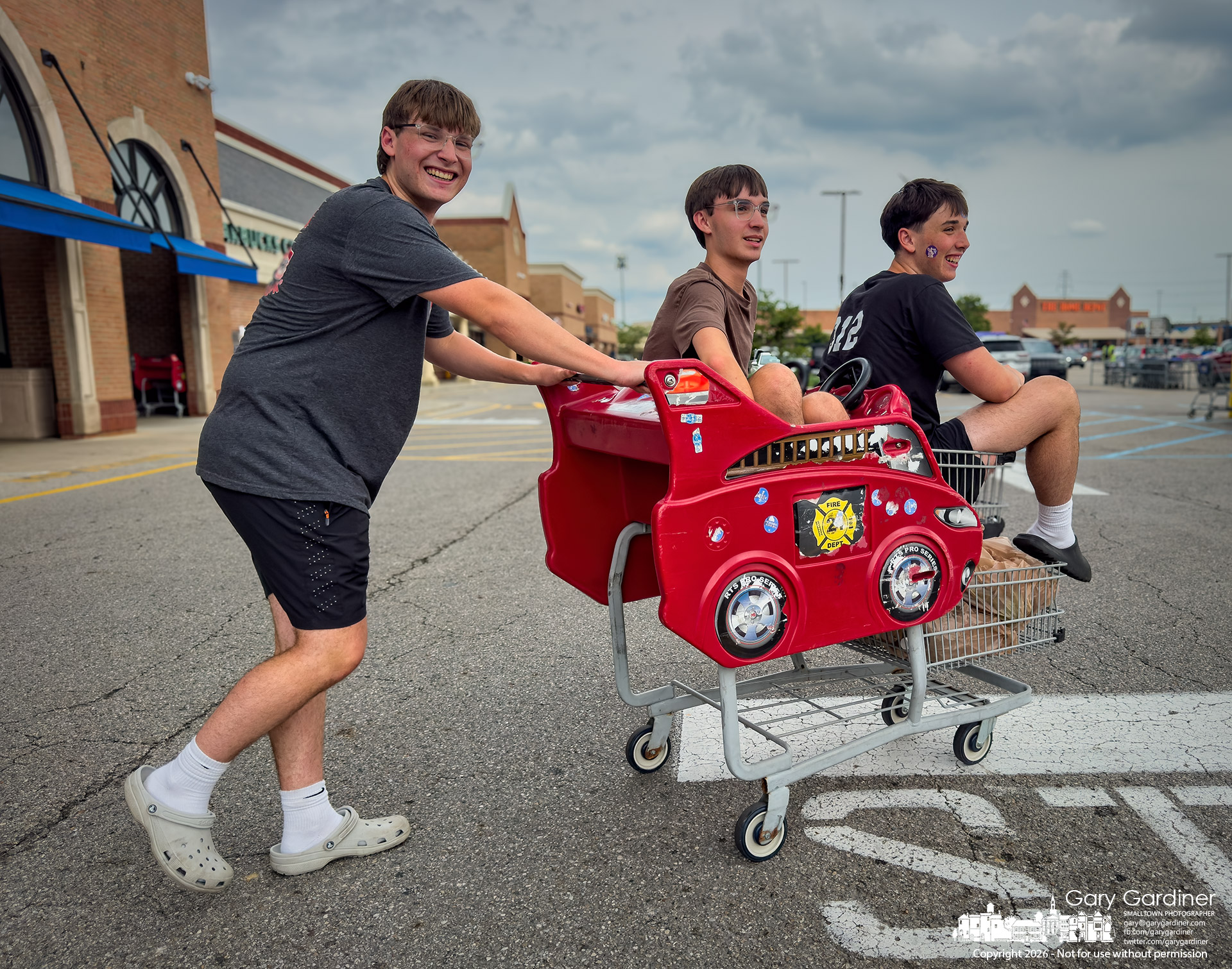 A trio of teenagers turned their shopping trip to Kroger into more than a hunt for groceries, making it an expression of youthful joy. (My Final Photo for August 13, 2026. Photo by Gary Gardiner)