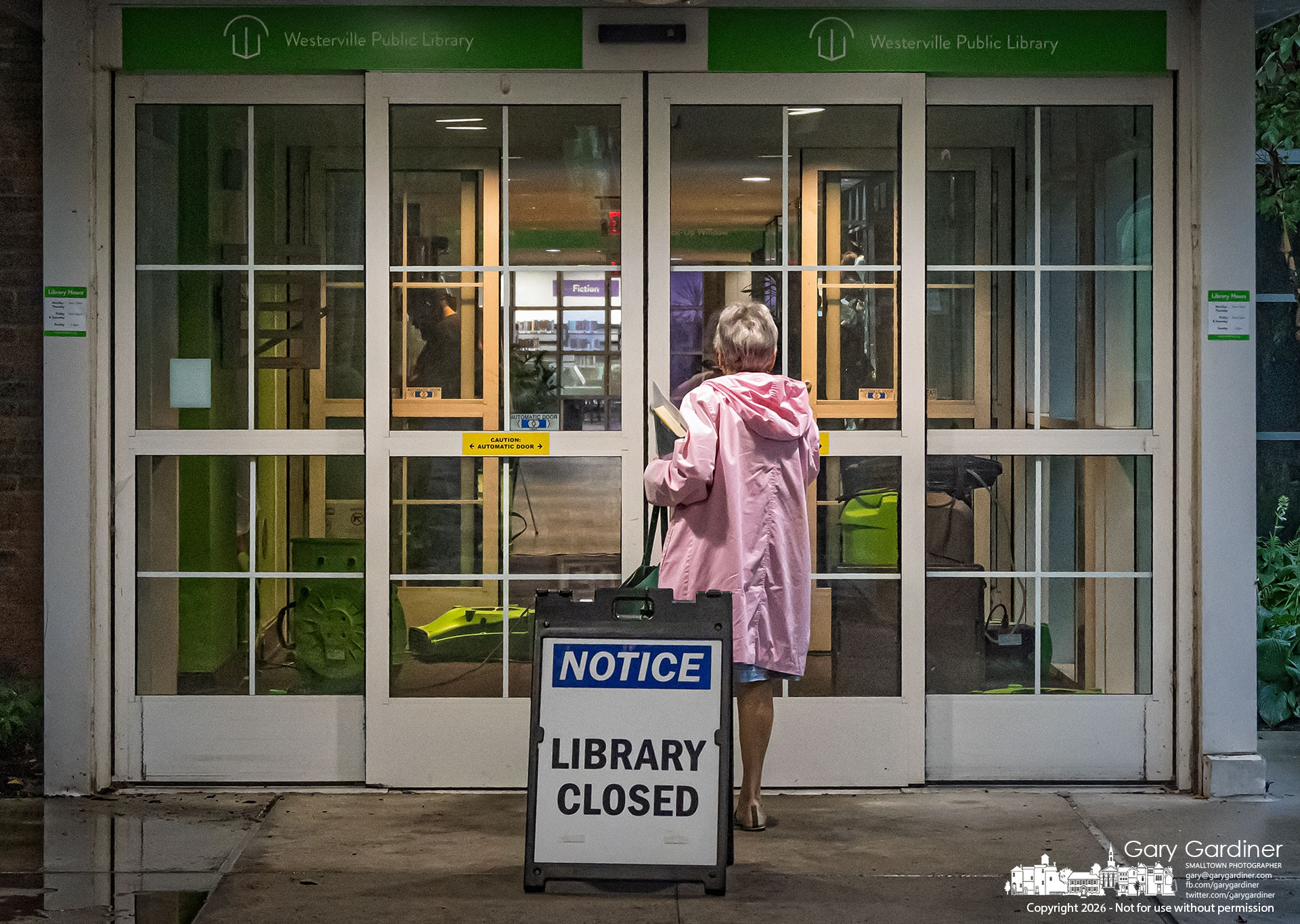 A woman studies her options after arriving at the Westerville Library on Monday, when a severe rainstorm caused the roof to leak into the entrance, closing the only entrance to the building. (My Final Photo for August 11, 2026. Photo by Gary Gardiner)