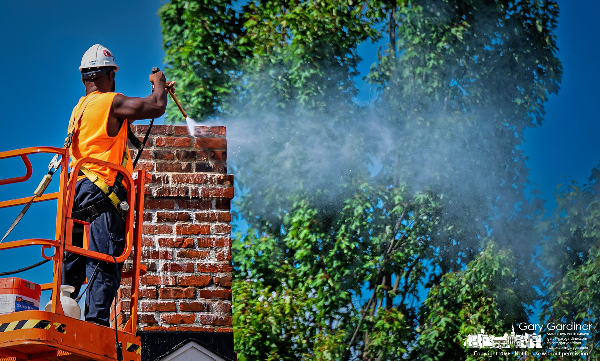 Contractors continued work restoring the Westerville Museum building, power-washing the roof and the restored brick main chimney. (My Final Photo for August 20, 2026. Photo by Gary Gardiner)