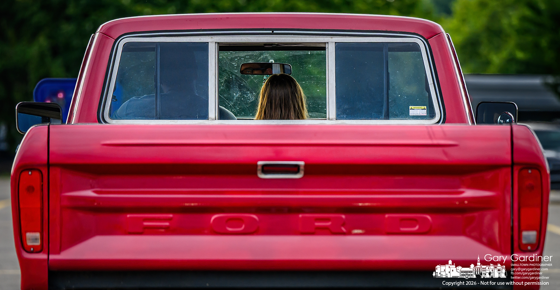Romance rides shotgun as a couple takes advantage of the bench seat in a vintage pickup truck, with a newly installed center seat belt keeping their ride safe and tender.