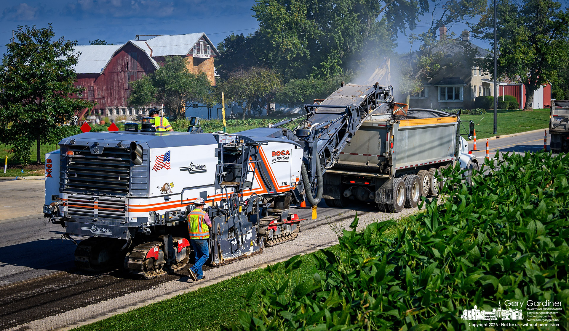 An asphalt milling machine moves along Africa Road between soybeans and barns at the Yarnell Farm to repave the road in one of the final projects at the Westar Place development. (My Final Photo for September 8, 2026. Photo by Gary Gardiner)