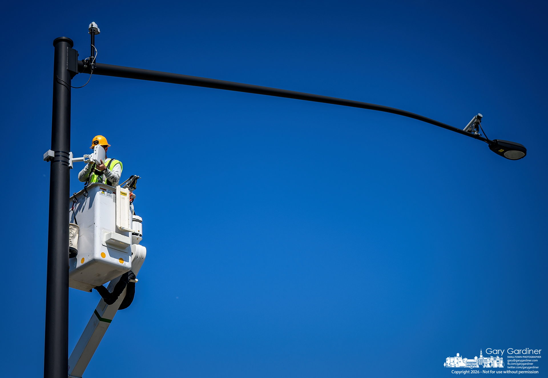 City electric workers install new traffic sensors on signal poles on Cleveland Ave. The radar-based devices will measure traffic flow and signal patterns. (My Final Photo for September 15, 2026. Photo by Gary Gardiner)