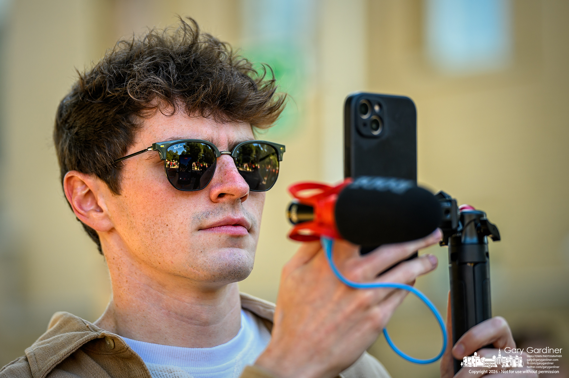 An Otterbein University senior communications student shoots video of the school's Homecoming parade Saturday afternoon. (My Final Photo for September 26, 2026. Photo by Gary Gardiner)