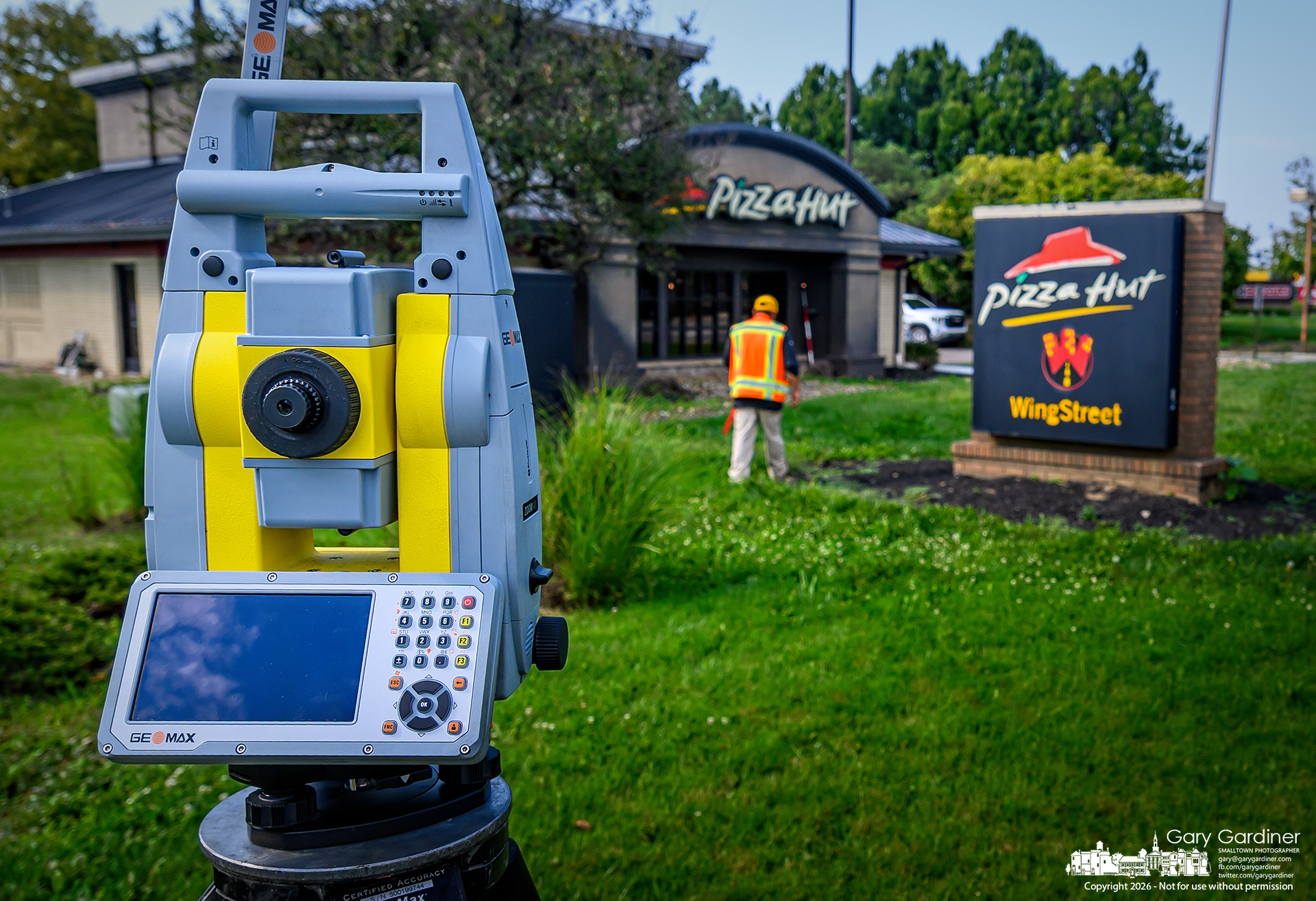A surveyor marks elevations and locations at the Pizza Hut on South State, saying he has no idea who requested the survey or why. (My Final Photo for September 16, 2026. Photo by Gary Gardiner)