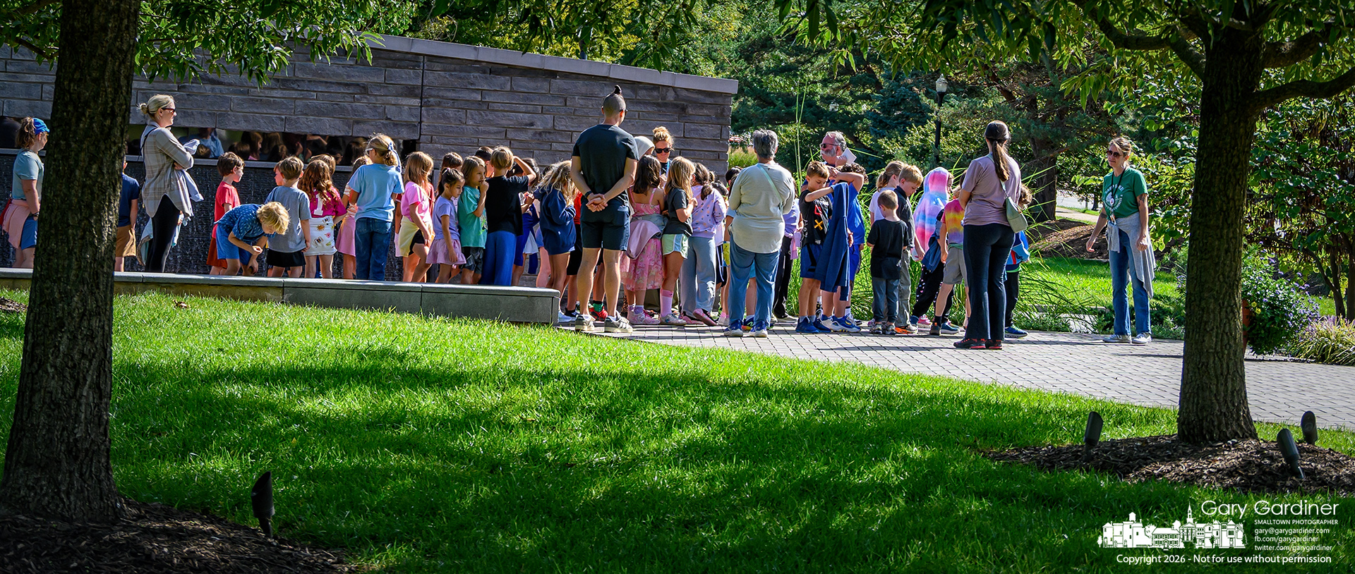 Retired Westerville Tom Ullom explains the significance of the Westerville Firefighters Memorial First Responders Park to a group of third graders on a field trip. (My Final Photo for September 14, 2026. Photo by Gary Gardiner)