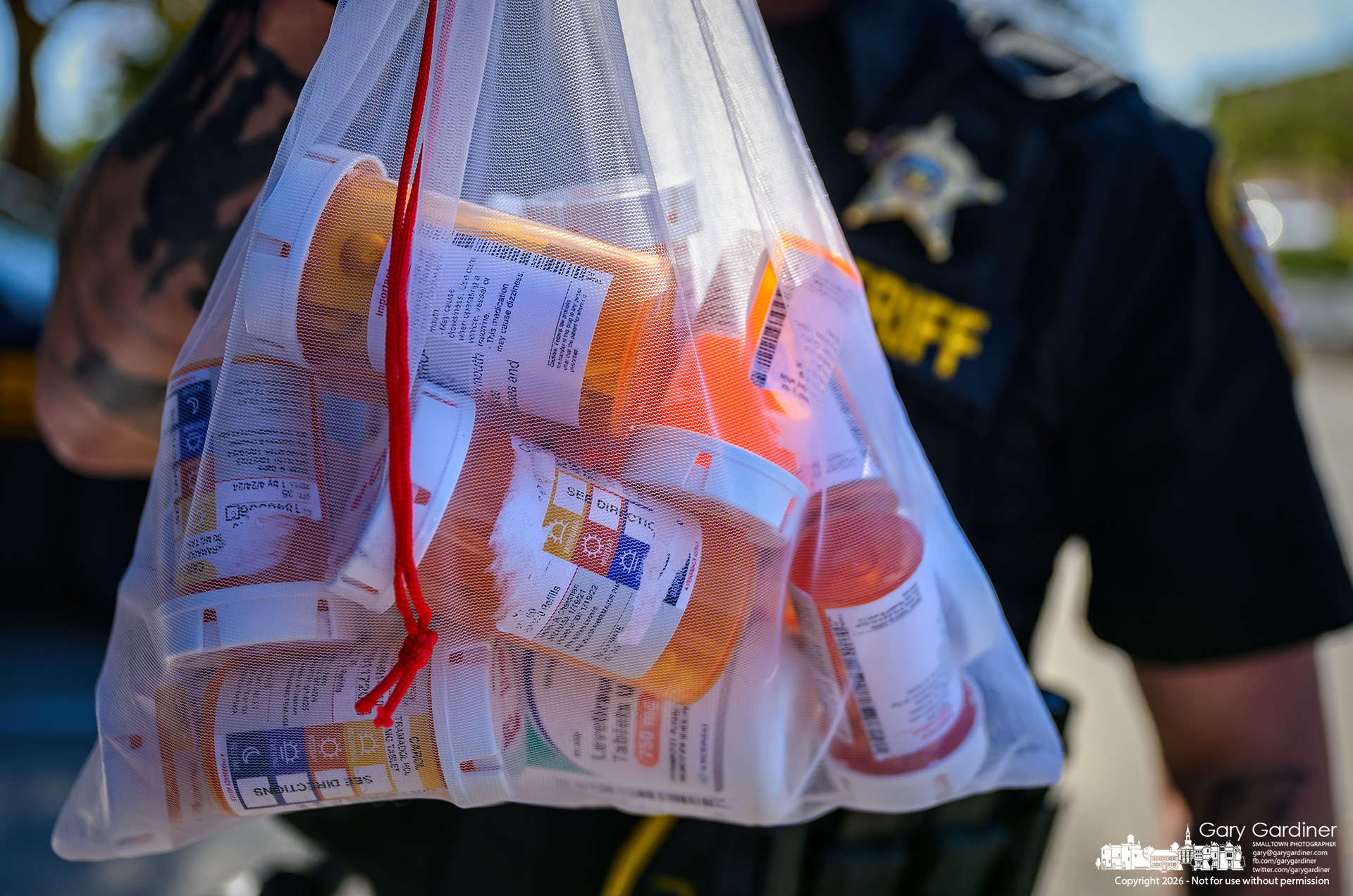 A Franklin County Sheriff's Deputy holds a bag of drugs surrendered at National Drug Take Back Day at Kroger on Schrock Road.(My Final Photo for October 24, 2026. Photo by Gary Gardiner)