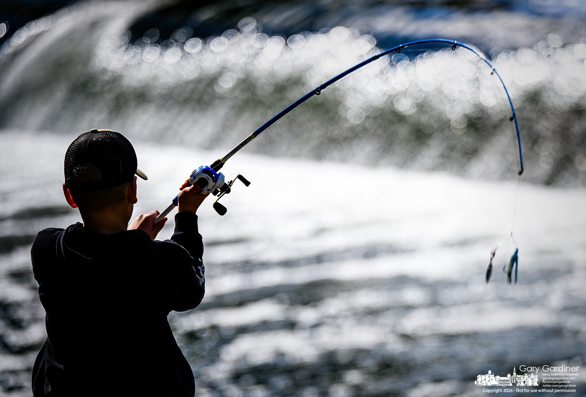 A young angler casts his lure into the glistening waters below the cam at Alum Creek Park North (My Final Photo for October 17, 2026. Photo by Gary Gardiner)