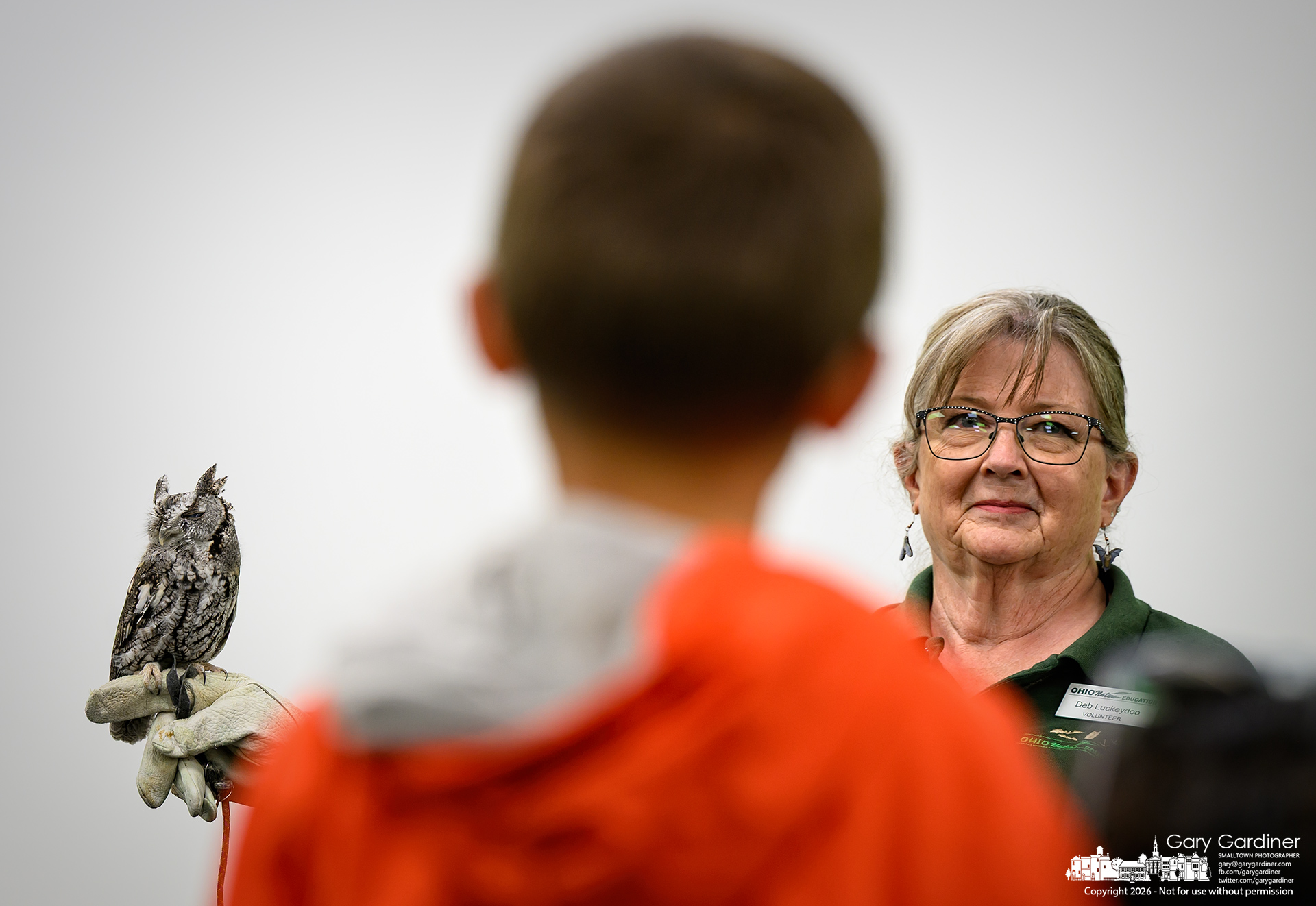 Deb Luckeydoo, a volunteer with the Ohio Wildlife Center, holds a small owl during a library presentation on bats and their predators. (My Final Photo for October 5, 2026. Photo by Gary Gardiner)