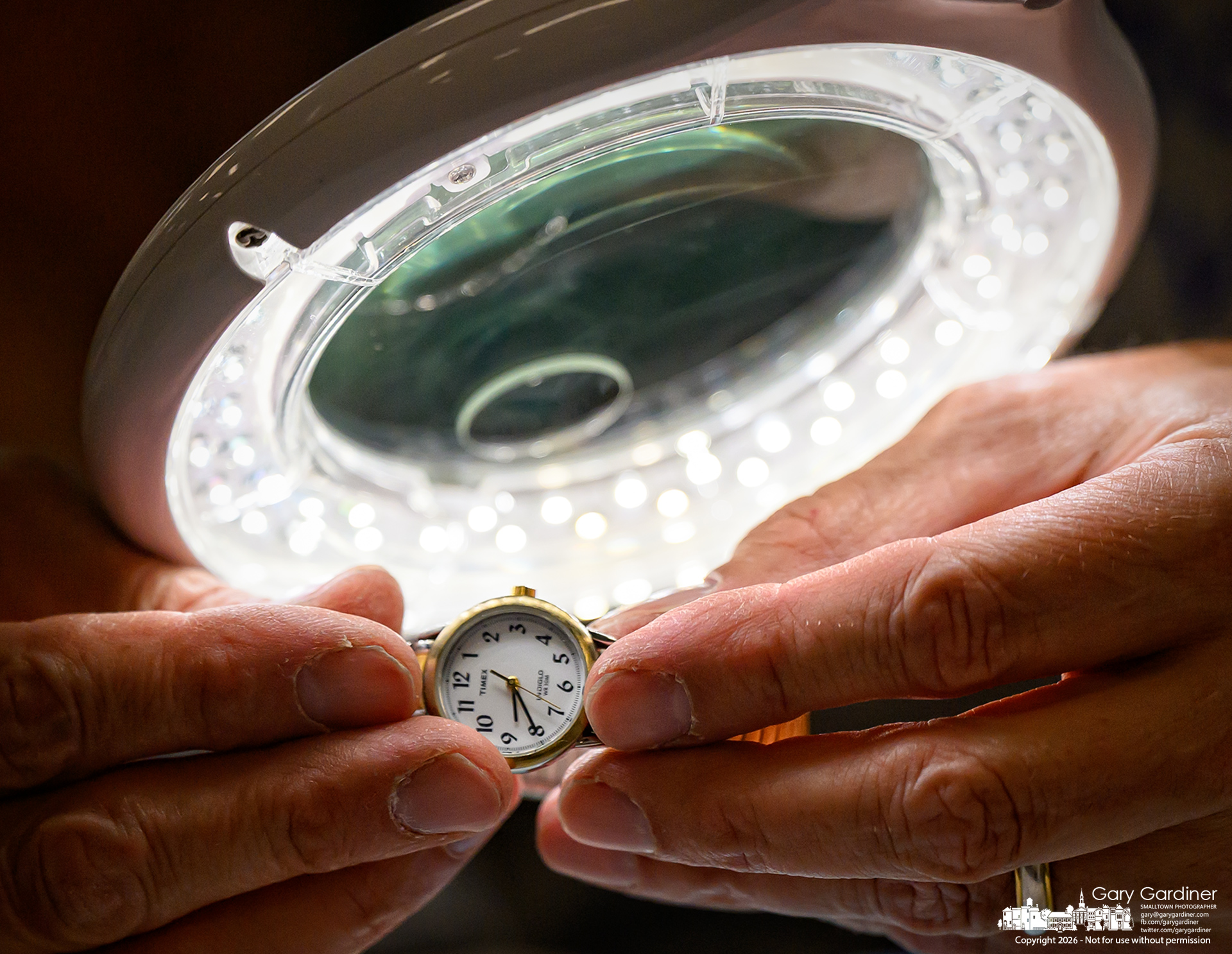 A damaged watch band is inspected under bright lights for possible repairs at Sustainable Westerville's Repair Cafe at Otterbein Saturday. (My Final Photo for October 10, 2026. Photo by Gary Gardiner)
