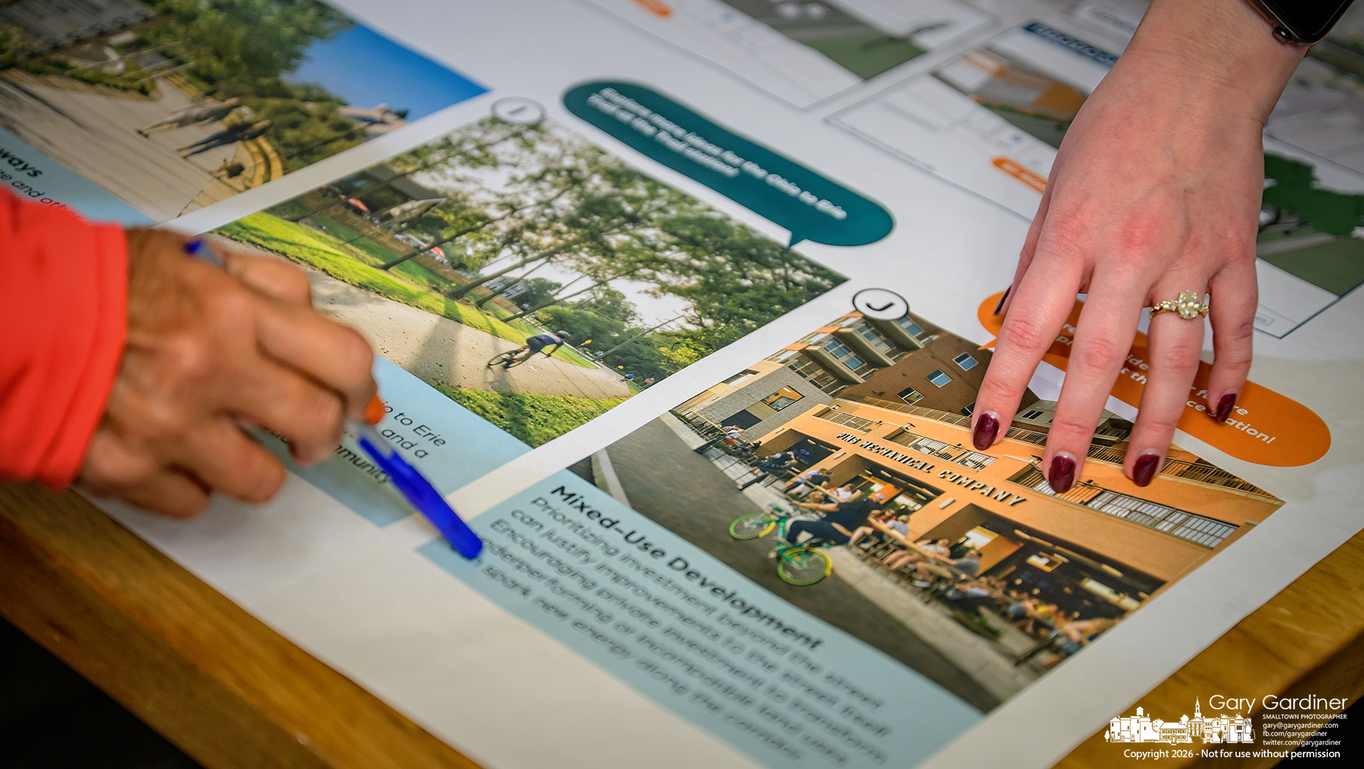 Hands reach to question and explain aspects of the city's South State Street Corridor display at the Let's Plan Westerville open meeting Thursday night. (My Final Photo for October 15, 2026. Photo by Gary Gardiner)