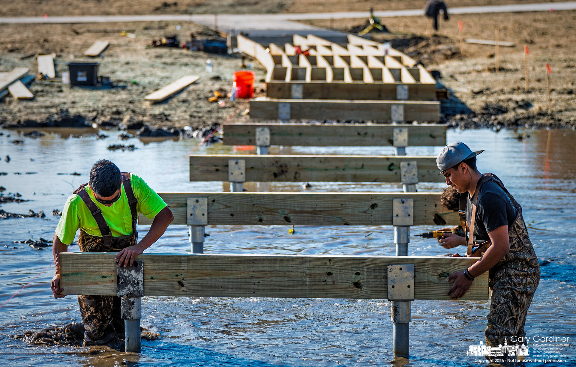 Contractors began building walkways over the new wetlands at Walnut Ridge Park on East Walnut on Thursday. (My Final Photo for October 29, 2026. Photo by Gary Gardiner)