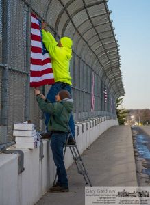 Blendon Township workers replace American flags on the Dempsey road bridge over I-270 earlier than expected after the severe winter damaged the flags beyond repair. My Final Photo for April 1, 2014. Blendon Township workers replace American flags on the Dempsey road bridge over I-270 earlier than expected after the severe winter damaged the flags beyond repair. My Final Photo for April 1, 2014.
