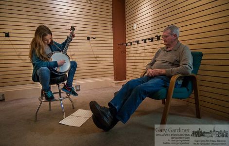 Eleven-year-old Joselin List practices before her banjo lessons at Uptown Strings while great-great-grandfather Ron Sherman watches and comments on her progress. My Final Photo for April 2, 2014. Eleven-year-old Joselin List practices before her banjo lessons at Uptown Strings while great-great-grandfather Ron Sherman watches and comments on her progress. My Final Photo for April 2, 2014.