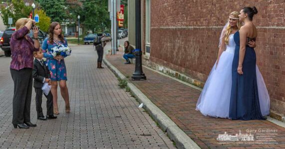 East Main Street in Uptown Westerville became a photo studio for several minutes as a bridal party in the foreground and a student in the background use the busy street as the location for their photo sessions. My Final Photo for Oct. 12, 2017. East Main Street in Uptown Westerville became a photo studio for several minutes as a bridal party in the foreground and a student in the background use the busy street as the location for their photo sessions. My Final Photo for Oct. 12, 2017.