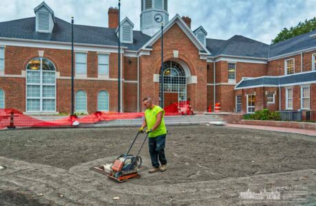 A landscaper runs a compactor over topsoil laid into the open space where sod grass will be laid in the courtyard of city hall. My Final Photo for Oct. 23, 2017. A landscaper runs a compactor over topsoil laid into the open space where sod grass will be laid in the courtyard of city hall. My Final Photo for Oct. 23, 2017.