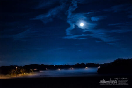 The soybean field at the Braun Farm sits under a cover of fog illuminated by streetlights and the full moon. My Final Photo for Oct. 5, 2017. The soybean field at the Braun Farm sits under a cover of fog illuminated by streetlights and the full moon. My Final Photo for Oct. 5, 2017.