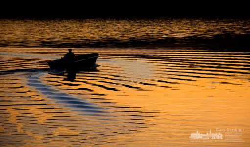 A fisherman’s boat creates a second set of wakes as he joins another angler traveling across Hoover Reservoir at sunrise. My Final Photo for Oct. 21, 2013. A fisherman’s boat creates a second set of wakes as he joins another angler traveling across Hoover Reservoir at sunrise. My Final Photo for Oct. 21, 2013.