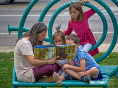 A mom and her three children share a book on the sound sculpture on the front lawn of the Westerville Library. My Final Photo for Oct. 10, 2017. A mom and her three children share a book on the sound sculpture on the front lawn of the Westerville Library. My Final Photo for Oct. 10, 2017.