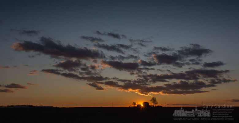 The sun sets behind a farmhouse on a ridgeline along a country road neat Hartford, Ohio. My Final Photo for Nov. 25, 2017. The sun sets behind a farmhouse on a ridgeline along a country road neat Hartford, Ohio. My Final Photo for Nov. 25, 2017.