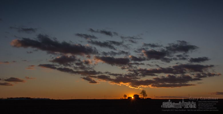 The sun sets behind a farmhouse on a ridgeline along a country road neat Hartford, Ohio. My Final Photo for Nov. 25, 2017. The sun sets behind a farmhouse on a ridgeline along a country road neat Hartford, Ohio. My Final Photo for Nov. 25, 2017.
