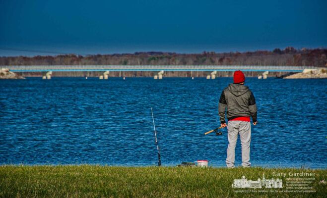A fisherman who appears to rather be fishing than shopping on Black Friday surveys the condition of one of his poles along the shore of Hoover Reservoir near the Walnut Street boat ramp. My Final Photo for Nov. 24, 2017. A fisherman who appears to rather be fishing than shopping on Black Friday surveys the condition of one of his poles along the shore of Hoover Reservoir near the Walnut Street boat ramp. My Final Photo for Nov. 24, 2017.