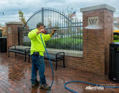 A technician uses a high-pressure washer to clean one of the corner structures at State and Schrock. My Final Photo for Nov. 2, 2017. A technician uses a high-pressure washer to clean one of the corner structures at State and Schrock. My Final Photo for Nov. 2, 2017.