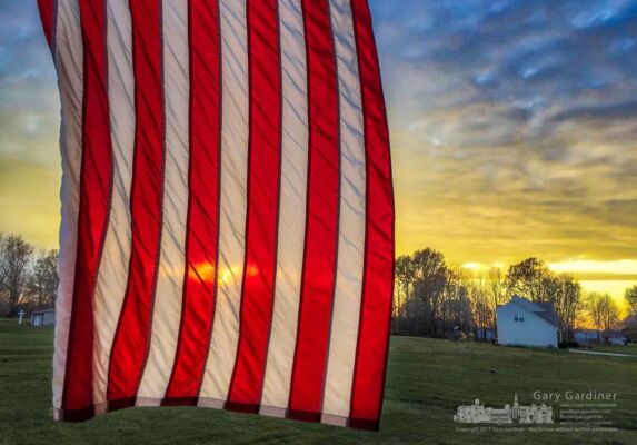 A United States of America flag flies in the cold breeze of sunset at the end of Thanksgiving Day. My Final Photo for Nov. 23, 2017. A United States of America flag flies in the cold breeze of sunset at the end of Thanksgiving Day. My Final Photo for Nov. 23, 2017.
