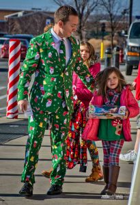 A father wearing the Christmas ugly sweater competition suit he will wear to a family gathering walks with his daughters to the Westerville Police W.A.R.M. collection boxes outside Walmart in Westerville. My Final Photo for Dec. 16, 2017. A father wearing the Christmas ugly sweater competition suit he will wear to a family gathering walks with his daughters to the Westerville Police W.A.R.M. collection boxes outside Walmart in Westerville. My Final Photo for Dec. 16, 2017.