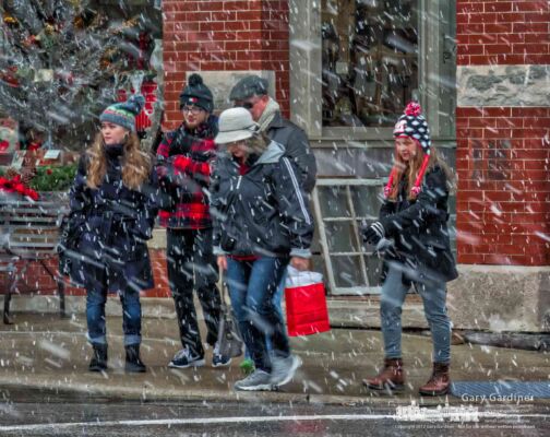 Shoppers in Uptown Westerville navigate their way a through a snow squall as they cross State Street at College Ave. My Final Photo for Dec. 23, 2017. Shoppers in Uptown Westerville navigate their way a through a snow squall as they cross State Street at College Ave. My Final Photo for Dec. 23, 2017.