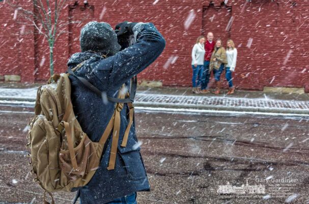 A photographer poses a family along East College for a portrait during the first major snow of the season Saturday afternoon in Uptown Westerville. My Final Photo for Dec. 9, 2017. A photographer poses a family along East College for a portrait during the first major snow of the season Saturday afternoon in Uptown Westerville. My Final Photo for Dec. 9, 2017.