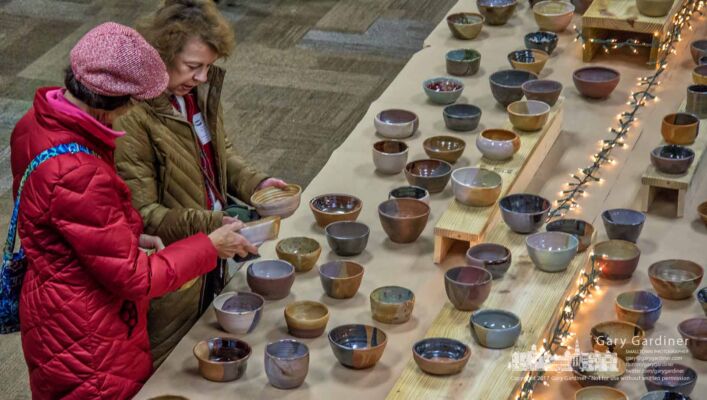 Two women sort through a table of soup bowls fashioned by Columbus Academy students for the Soup for Shelter fundraiser at Otterbein University for Westerville Habitat Partnership. My Final Photo for Dec. 8, 2017. Two women sort through a table of soup bowls fashioned by Columbus Academy students for the Soup for Shelter fundraiser at Otterbein University for Westerville Habitat Partnership. My Final Photo for Dec. 8, 2017.