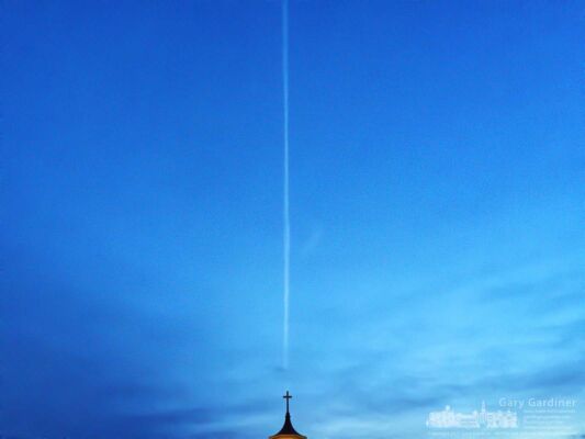 An early morning flight creates a contrail behind the cross atop the old steeple for St. Paul the Apostle Catholic Church in Westerville. My Final Photo for Dec. 17, 2017. An early morning flight creates a contrail behind the cross atop the old steeple for St. Paul the Apostle Catholic Church in Westerville. My Final Photo for Dec. 17, 2017.