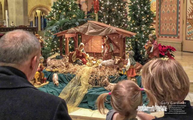 A family examines the nativity scene adjacent to the altar after the Christmas Eve morning Mass at St. Paul Catholic Church in Westerville. My Final Photo for Dec. 24, 2017. A family examines the nativity scene adjacent to the altar after the Christmas Eve morning Mass at St. Paul Catholic Church in Westerville. My Final Photo for Dec. 24, 2017.